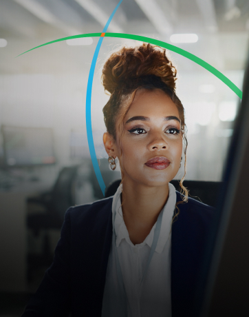 banner showing a business professional looking at a monitor while sitting in a modern workspace