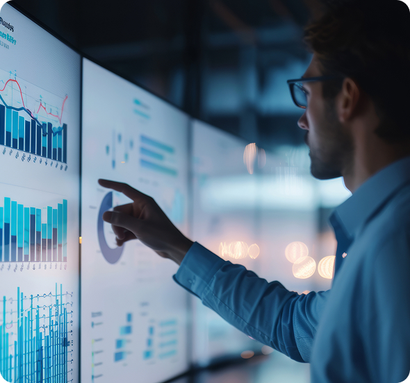 a man pointing at an analytics dashboard displayed on a computer screen