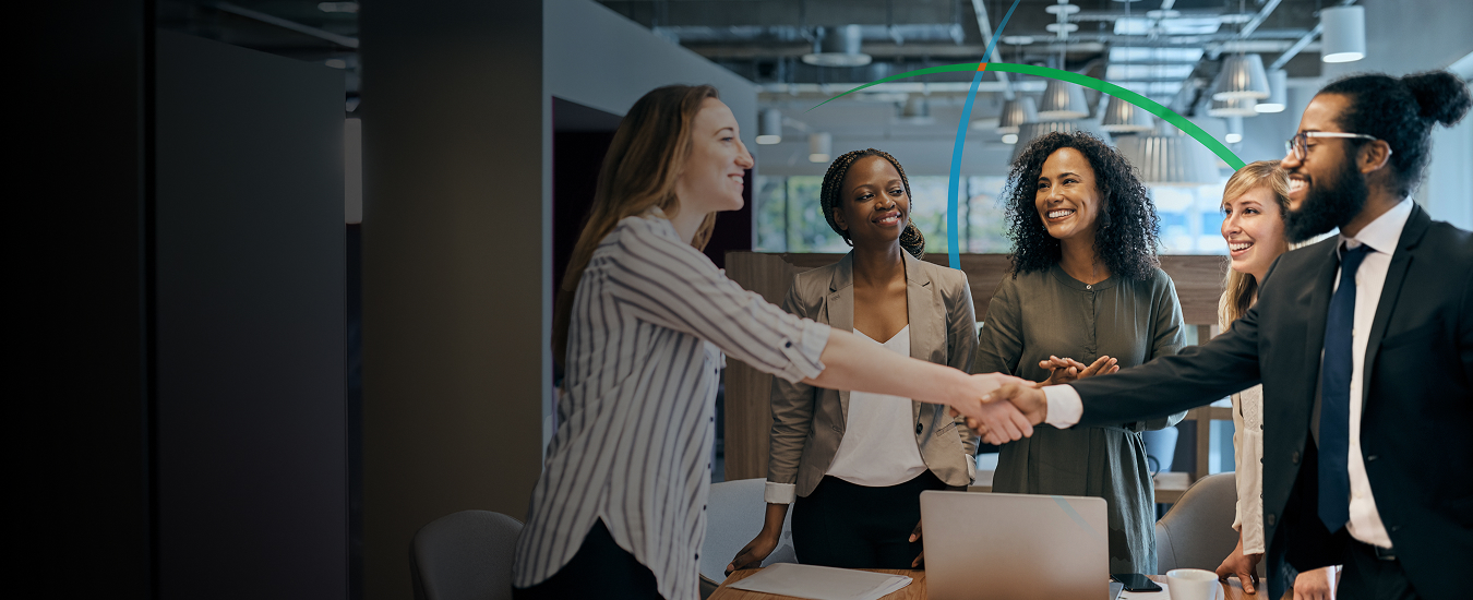 banner showing business professionals smiling and shaking hands in a conference room