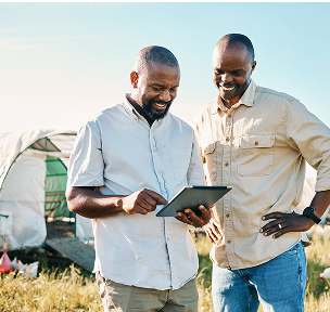 two men looking at a tablet screen
