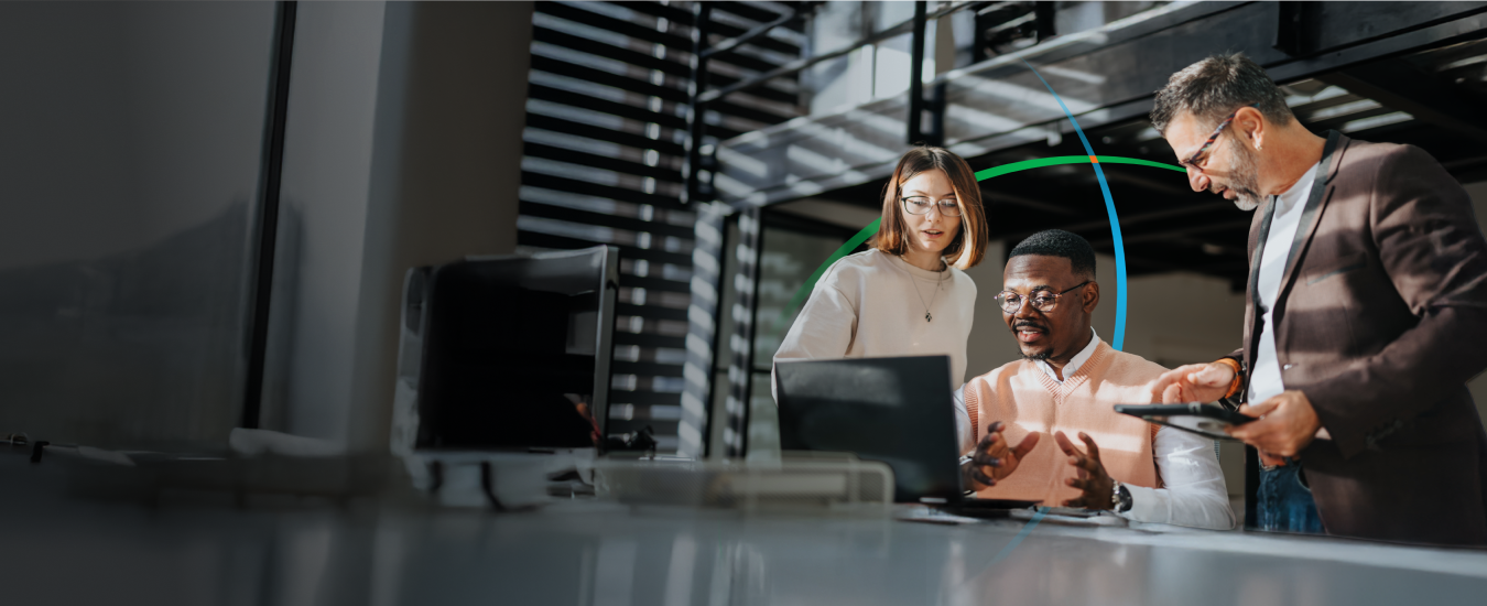 banner showing three business professionals having a discussion while looking at a laptop screen