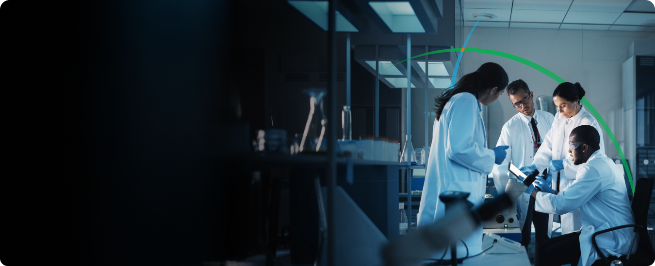 banner showing a group of medical professionals in a lab having a discussion while looking at a tablet screen