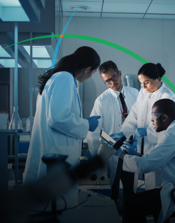 banner showing a group of medical professionals in a lab having a discussion while looking at a tablet screen